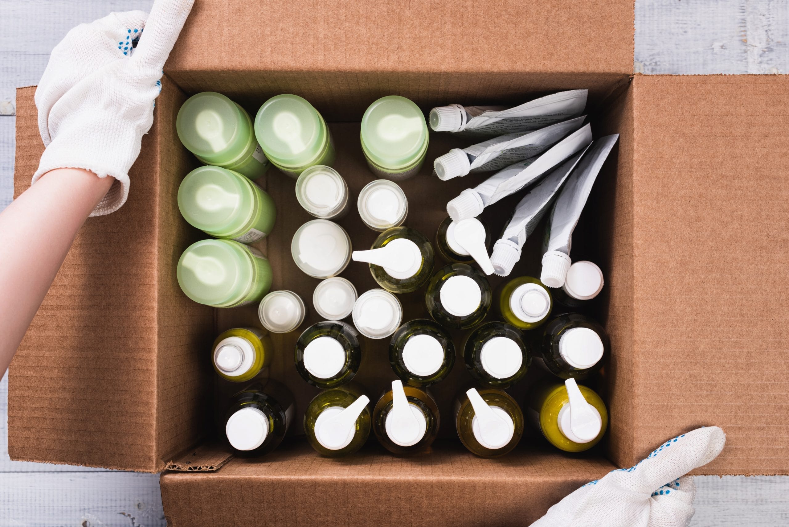 Box of assorted plastic bottles and pouches